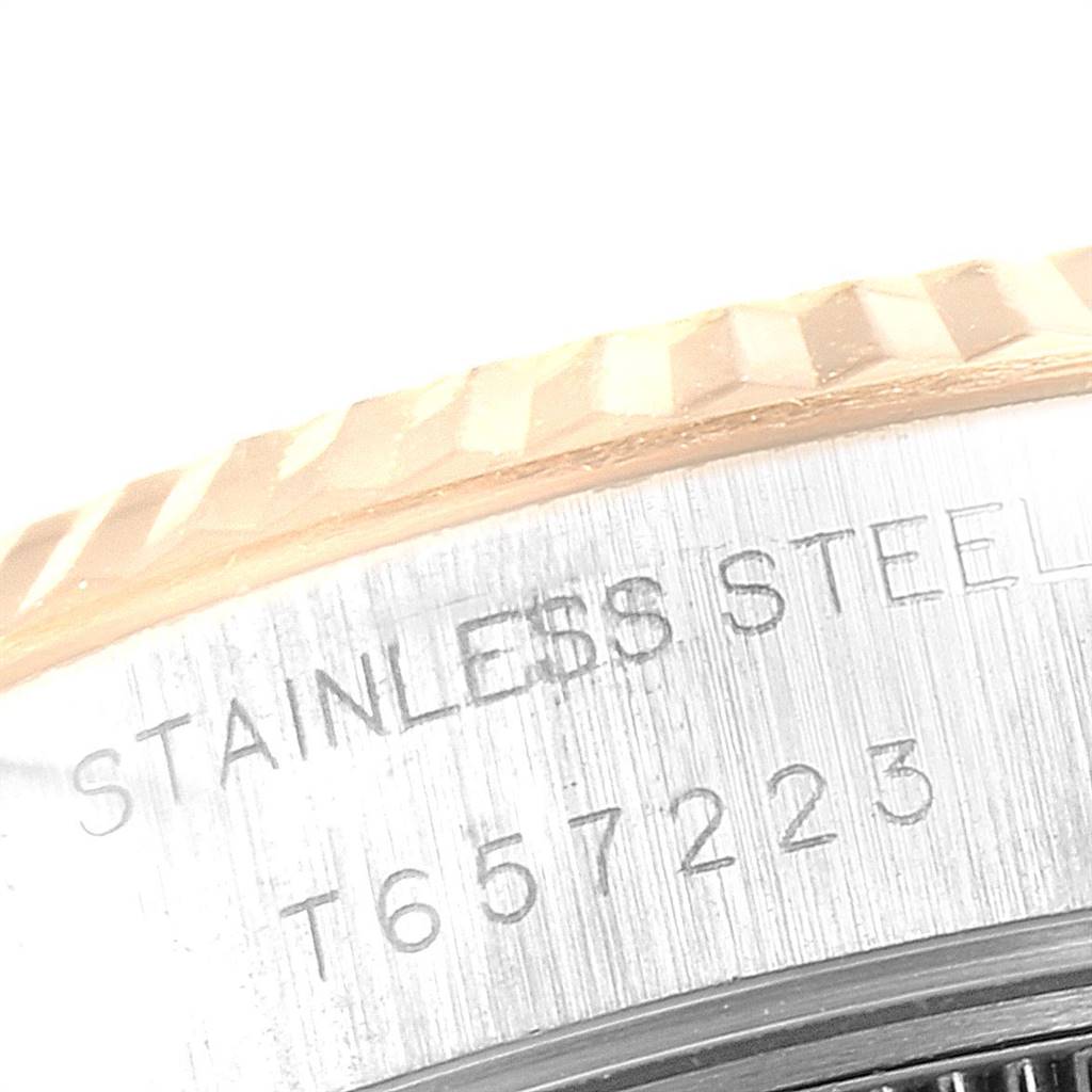 The close-up angle of this Rolex Datejust 69173 Women
s Stainless Steel Beige Dial 69173 Women
s Stainless Steel Beige Dial watch shows the fluted bezel and part of the engraved stainless steel caseback.