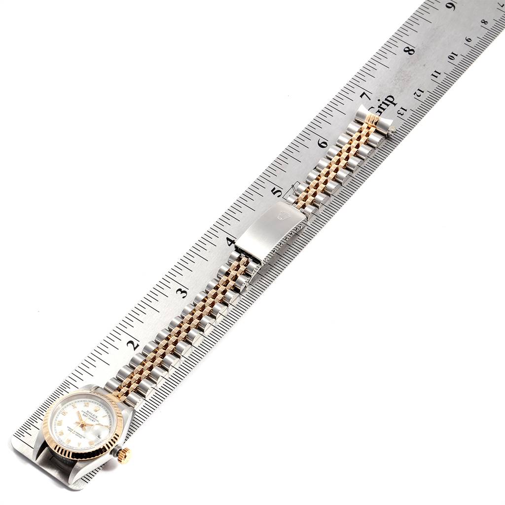 The image shows a Rolex Datejust 69173 Women's Stainless Steel White Dial 69173 Women's Stainless Steel White Dial watch laid flat next to a ruler, highlighting its bracelet and clasp.