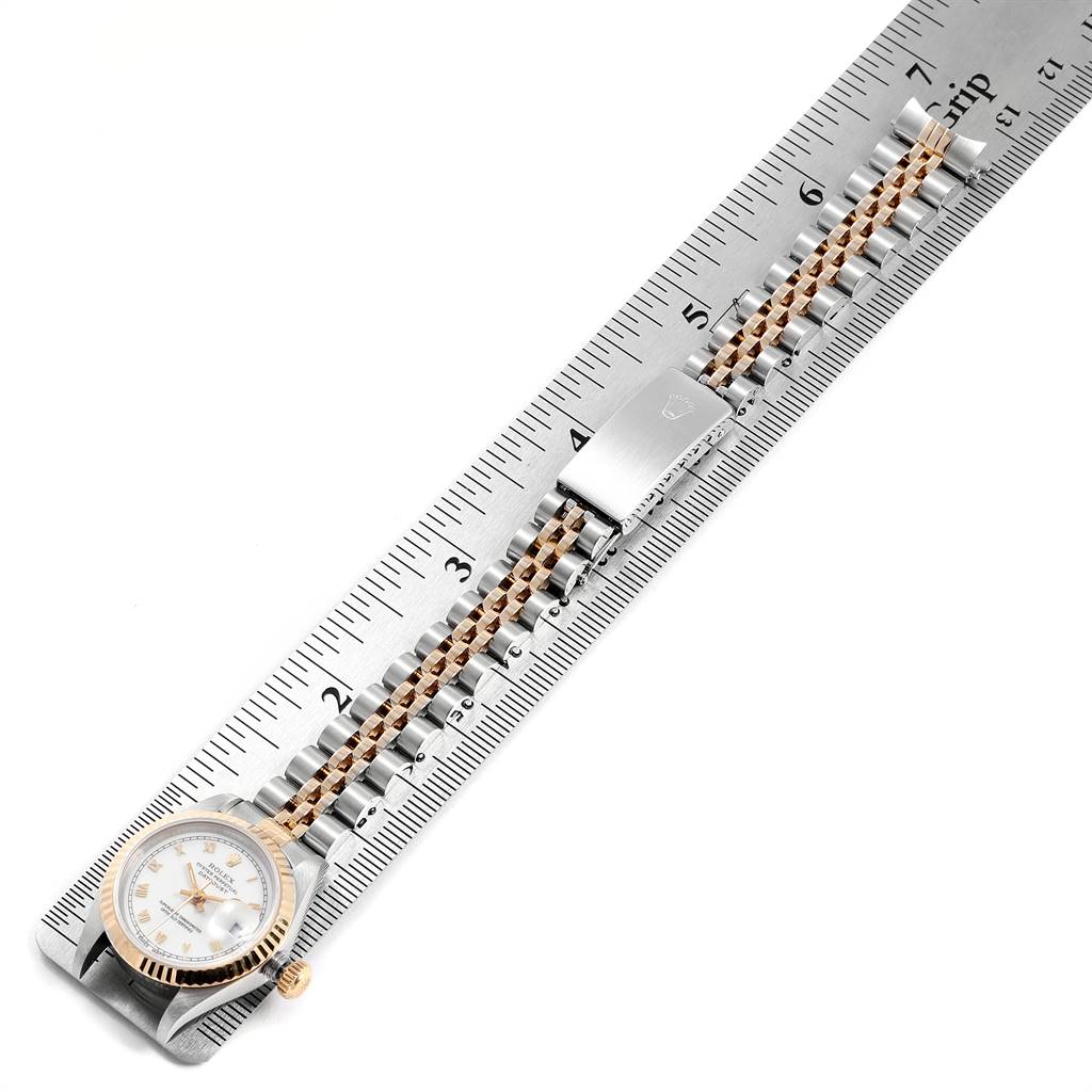 The image shows a Rolex Datejust 69173 Women's Stainless Steel White Dial 69173 Women's Stainless Steel White Dial watch placed on a ruler, displaying its two-tone bracelet and clasp.