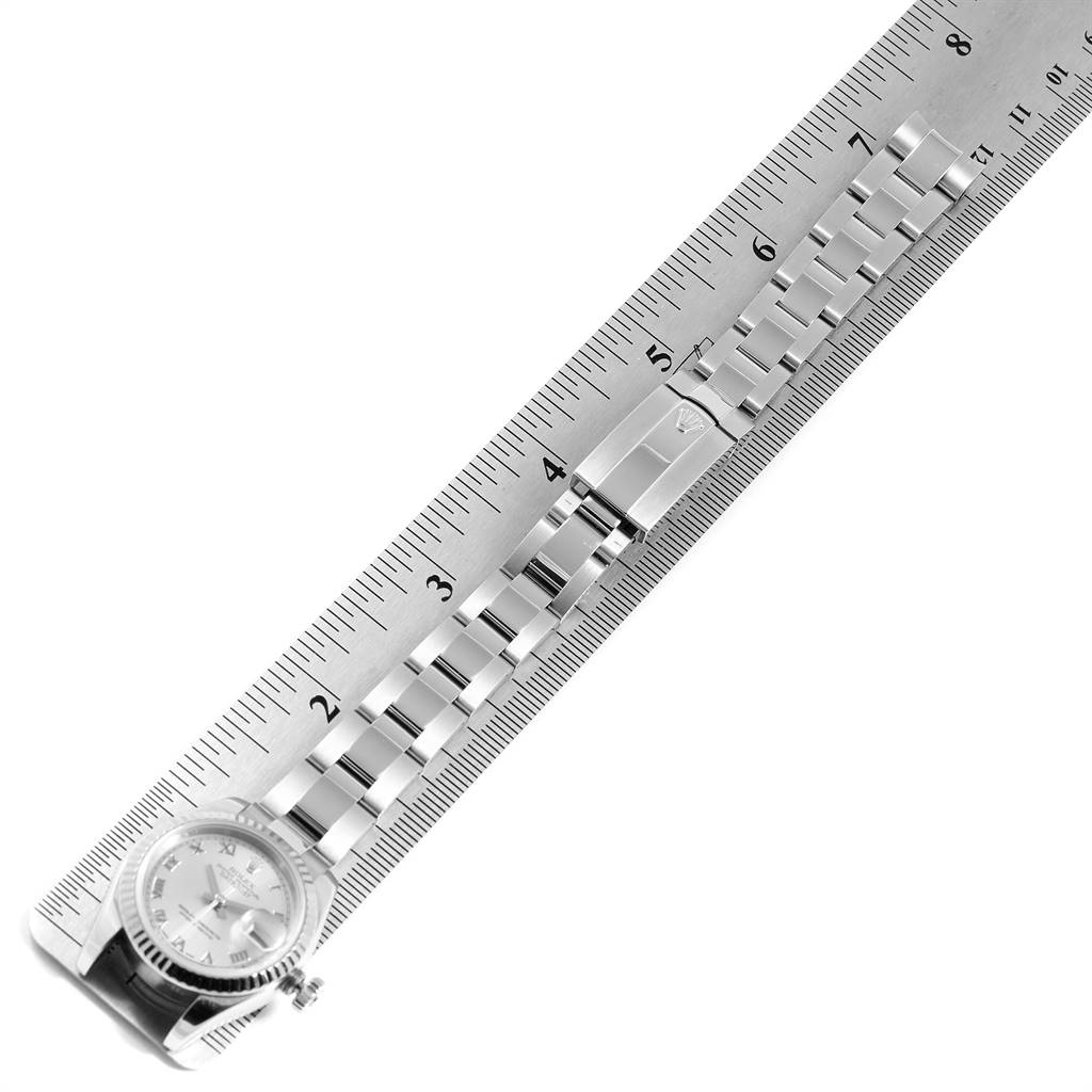 The image shows the Rolex Datejust 179174 Women's Stainless Steel Grey Dial 179174 Women's Stainless Steel Grey Dial watch laid flat along a ruler, displaying its bracelet and part of the watch face.