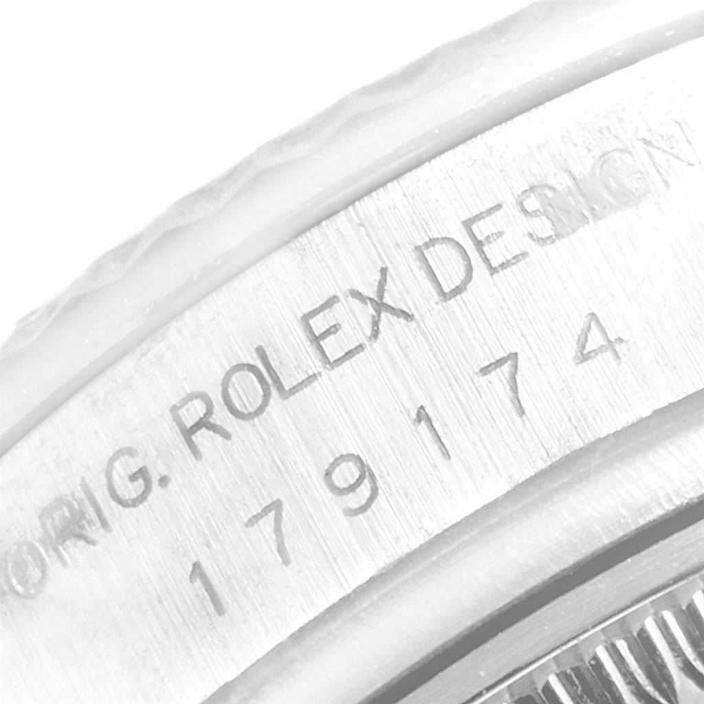 This close-up image shows the engraved serial number on the side of a Rolex Datejust 179174 Women's Stainless Steel Grey Dial 179174 Women's Stainless Steel Grey Dial watch case.