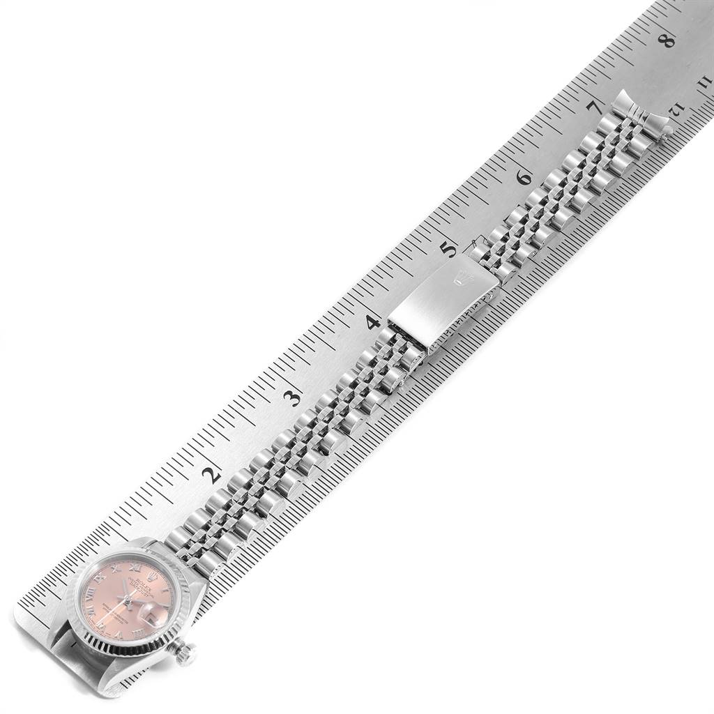 The image shows a Rolex Datejust 79174 Women's Stainless Steel Pink Dial 79174 Women's Stainless Steel Pink Dial watch laying flat with the case, face, and full bracelet visible next to a ruler.