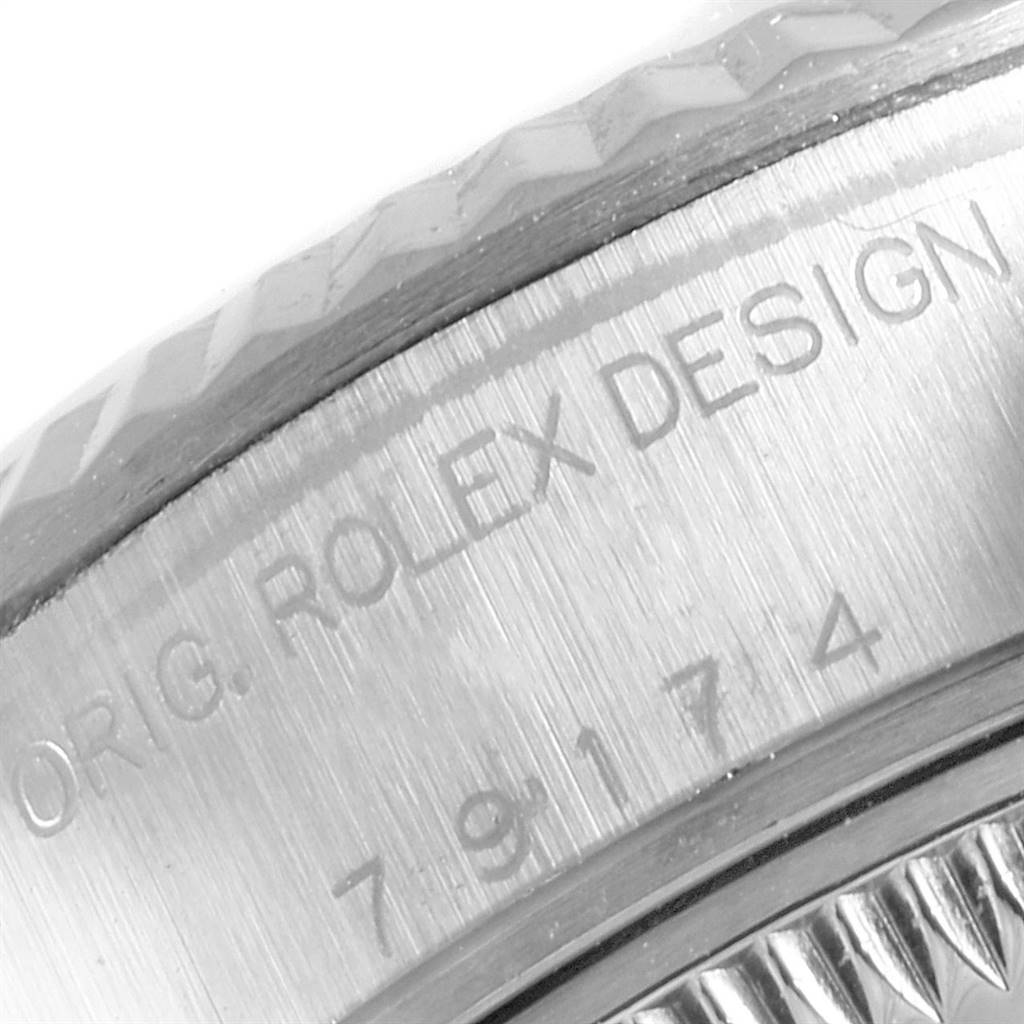 This image shows a close-up of the casing with engraved text on a Rolex Datejust 79174 Women's Stainless Steel Pink Dial 79174 Women's Stainless Steel Pink Dial watch.