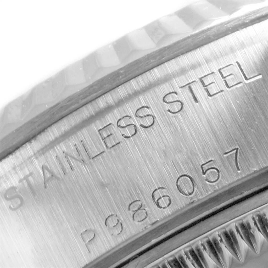 The image shows a close-up of the serial number and "STAINLESS STEEL" engravings on a Rolex Datejust 79174 Women's Stainless Steel Pink Dial 79174 Women's Stainless Steel Pink Dial watch case.