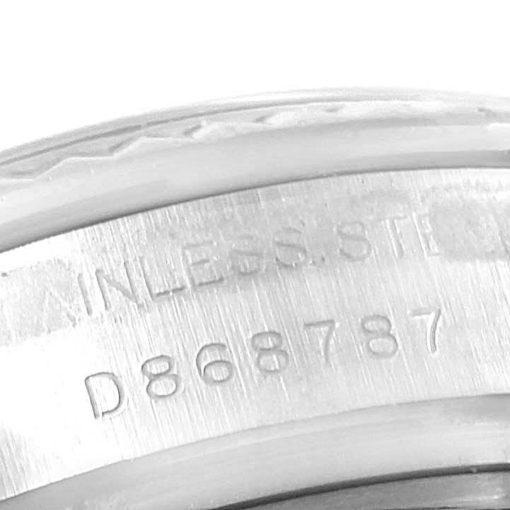 This image shows the serial number engraved on the side of the case of a Rolex Datejust 179174 Women's Stainless Steel Black Dial 179174 Women's Stainless Steel Black Dial watch.