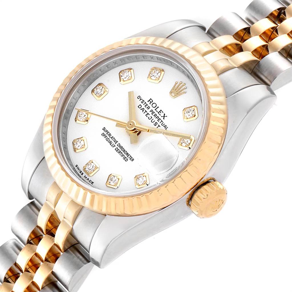 The image shows a Rolex Datejust 179173 Women's Steel and Gold (two tone) White Dial 179173 Women's Steel and Gold (two tone) White Dial watch at a tilted angle, highlighting the face, bezel, crown, and part of the bracelet.