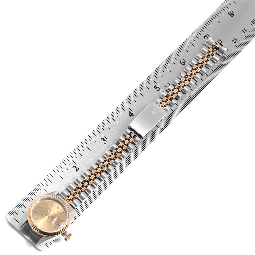 The image shows a Rolex Datejust 69173 Women's Steel and Gold (two tone) Champagne Dial 69173 Women's Steel and Gold (two tone) Champagne Dial watch placed over a ruler, highlighting the face and bracelet.