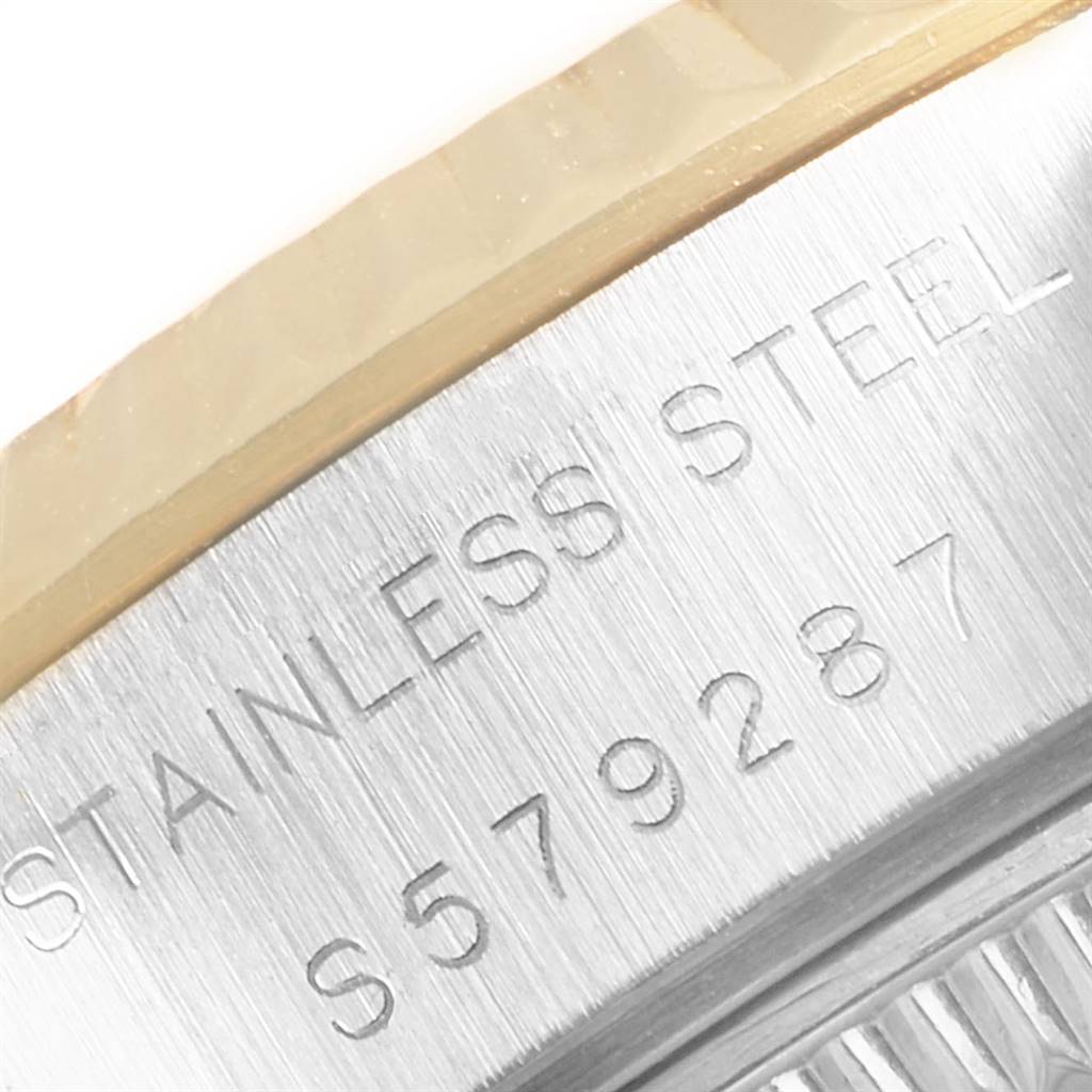 This image shows a close-up of the case side of a Rolex Datejust 69173 Women's Steel and Gold (two tone) Champagne Dial 69173 Women's Steel and Gold (two tone) Champagne Dial model, featuring the "STAINLESS STEEL" engraving and serial number.