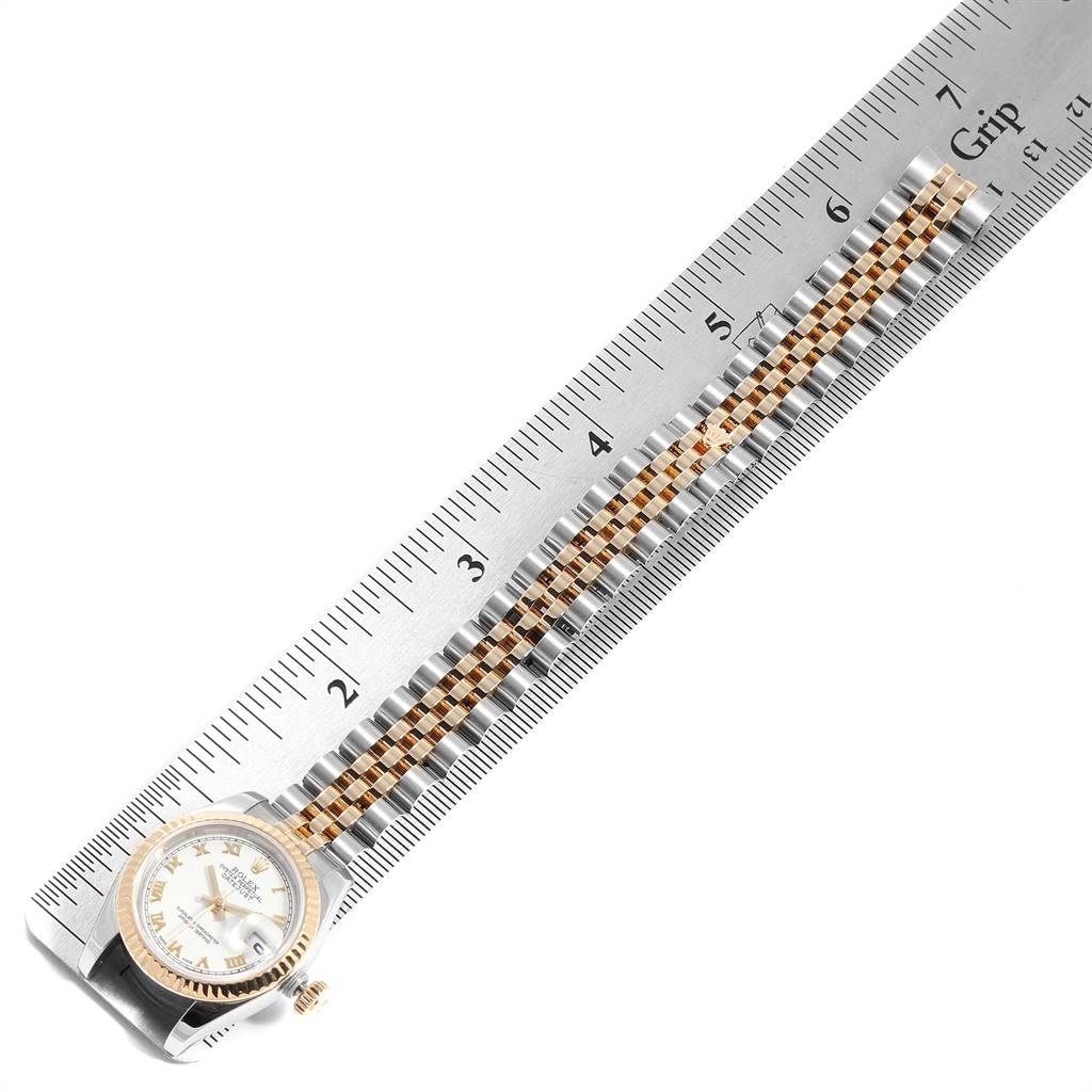 The image shows the Rolex Datejust 179173 Women's Steel and Gold (two tone) White Dial 179173 Women's Steel and Gold (two tone) White Dial watch face and strap, with the strap laid against a ruler for measurement.