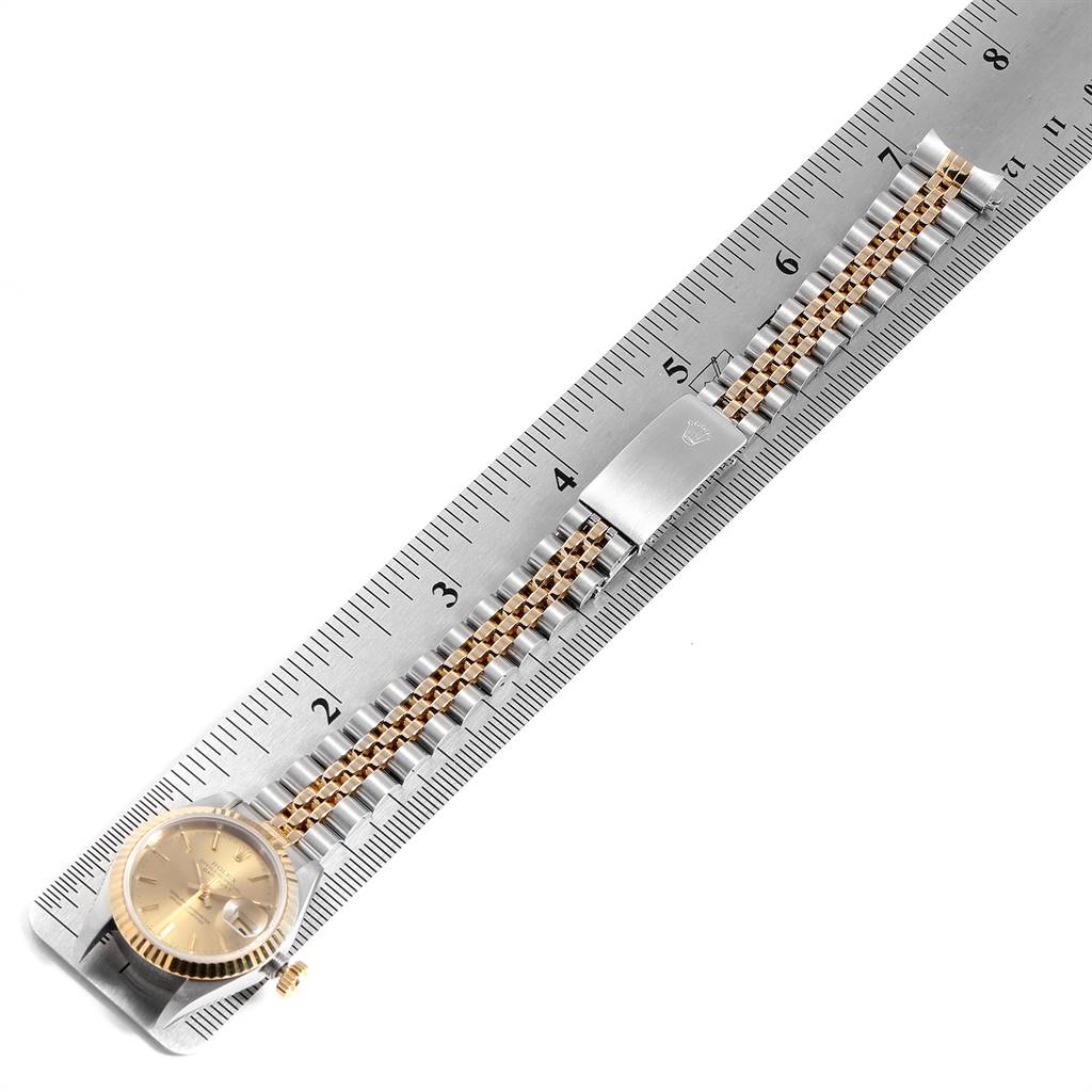 The image shows an overhead view of a Rolex Datejust 69173 Women's Stainless Steel Champagne Dial 69173 Women's Stainless Steel Champagne Dial watch, specifically its face, bezel, bracelet, and clasp against a ruler.