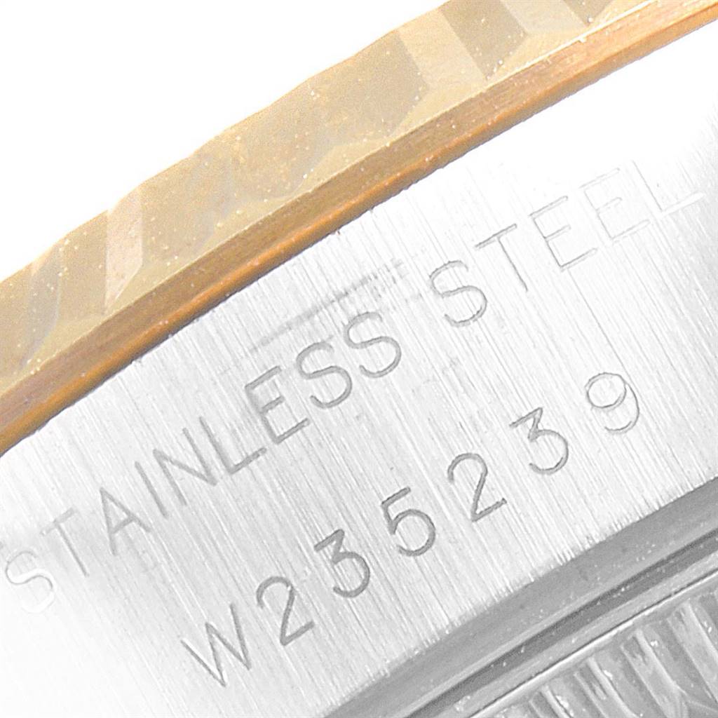 This close-up shows the engraved stainless steel case side and fluted bezel of the Rolex Datejust 69173 Women's Stainless Steel Champagne Dial 69173 Women's Stainless Steel Champagne Dial watch.