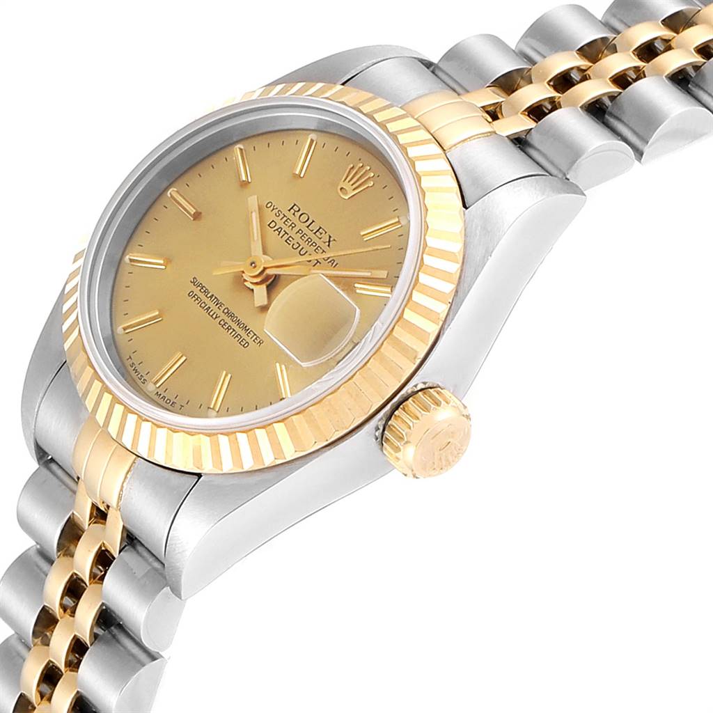 This image shows a side angle view of the Rolex Datejust 69173 Women's Stainless Steel Champagne Dial 69173 Women's Stainless Steel Champagne Dial watch highlighting its gold bezel, crown, and part of the bracelet.