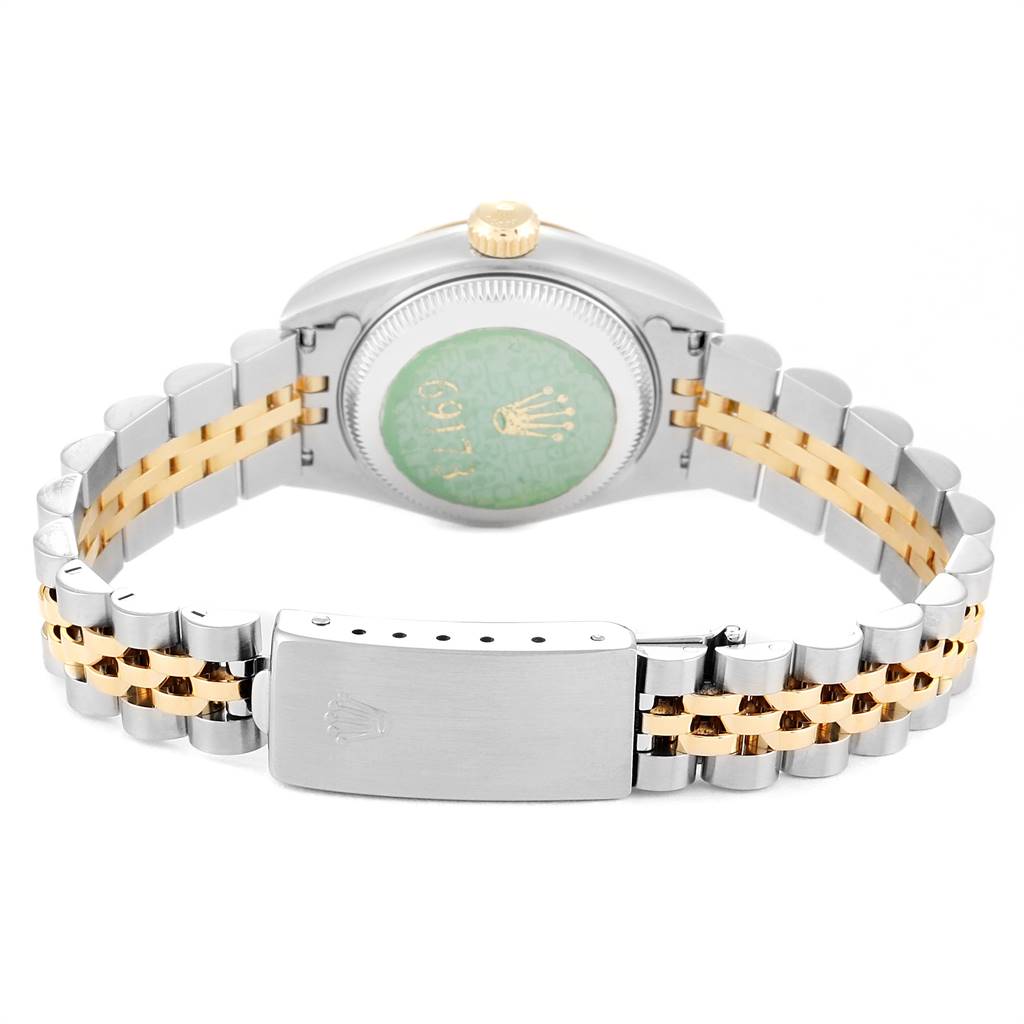 This image shows the backside of a Rolex Datejust 69173 Women's Stainless Steel Champagne Dial 69173 Women's Stainless Steel Champagne Dial watch including the case back, the crown, and the band with the clasp.