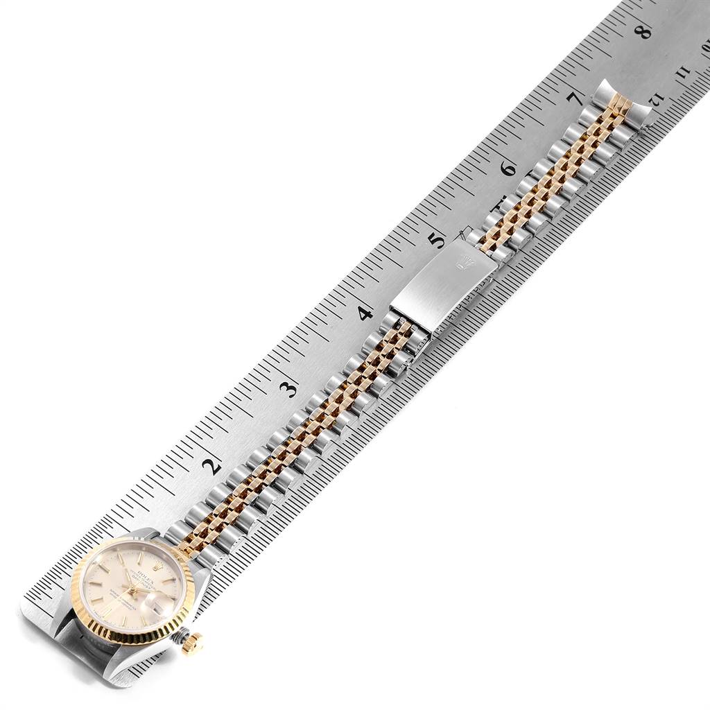 The Rolex Datejust 69173 Women's Stainless Steel Silver Dial 69173 Women's Stainless Steel Silver Dial watch is shown from the top view with its face, crown, and entire bracelet along a ruler for scale.