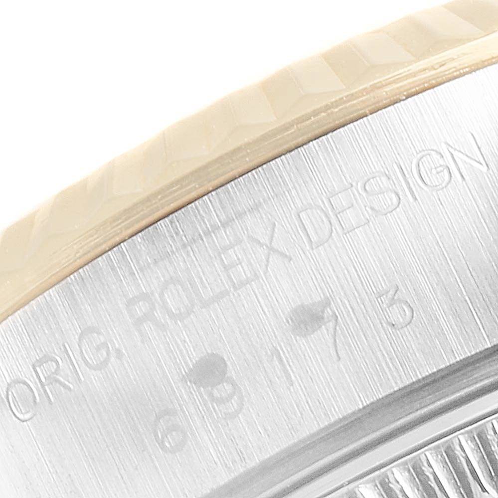 The image shows a close-up of the engraved bezel and edge of the case back of a Rolex Datejust 69173 Women's Stainless Steel Silver Dial 69173 Women's Stainless Steel Silver Dial watch.