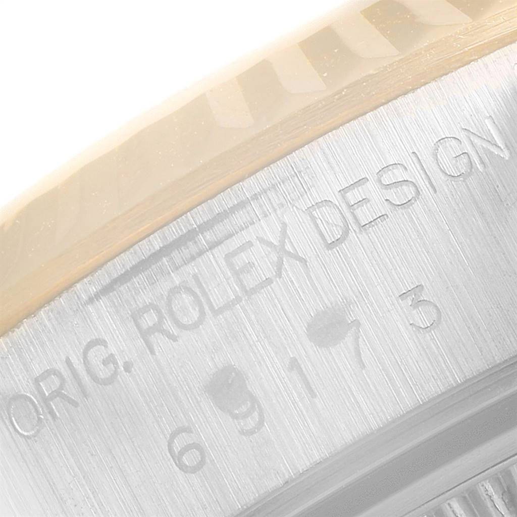 The image shows a close-up of the side engraving on the casing of a Rolex Datejust 69173 Women's Stainless Steel Champagne Dial 69173 Women's Stainless Steel Champagne Dial watch.