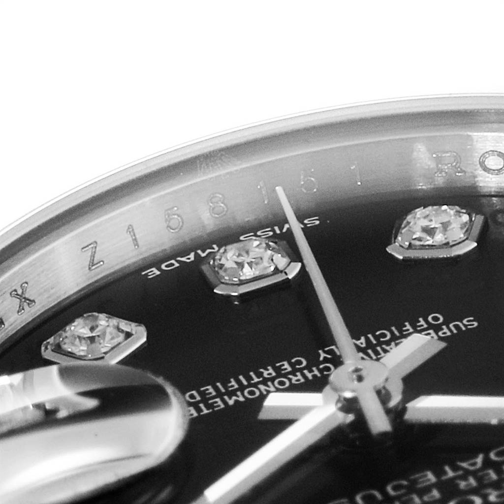 This image shows a close-up of the Rolex Datejust 179174 Women
s Stainless Steel Black Dial 179174 Women
s Stainless Steel Black Dial watch dial, highlighting the diamond hour markers, hands, and part of the rehaut.