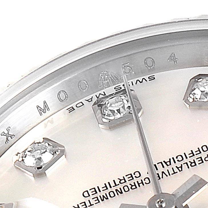 A close-up view of the Rolex Datejust 179174 Women
s Stainless Steel Mother of Pearl Dial 179174 Women
s Stainless Steel Mother of Pearl Dial watch dial, showing part of the bezel, diamonds, and the "SWISS MADE" inscription.