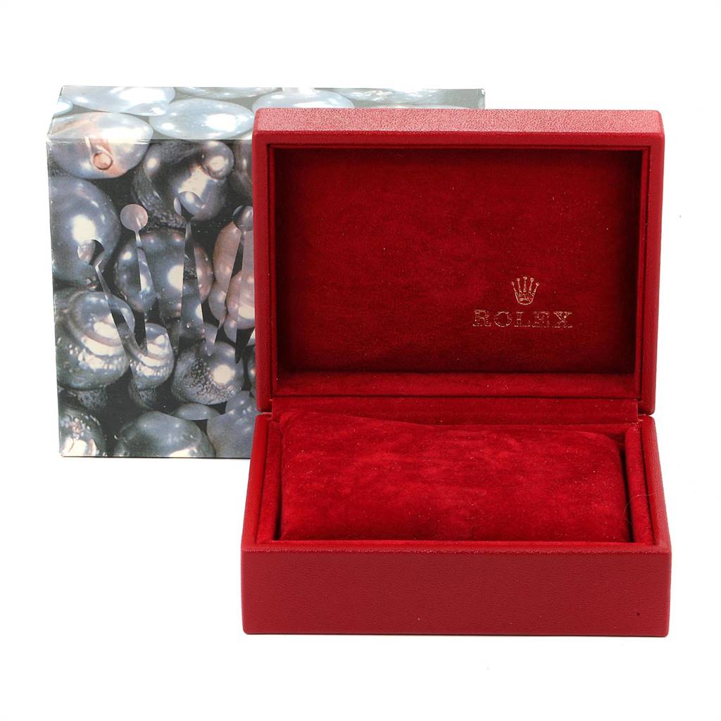This image shows an open red Rolex Datejust 79173 Women's Stainless Steel Grey Dial 79173 Women's Stainless Steel Grey Dial watch box with a patterned outer box in the background.