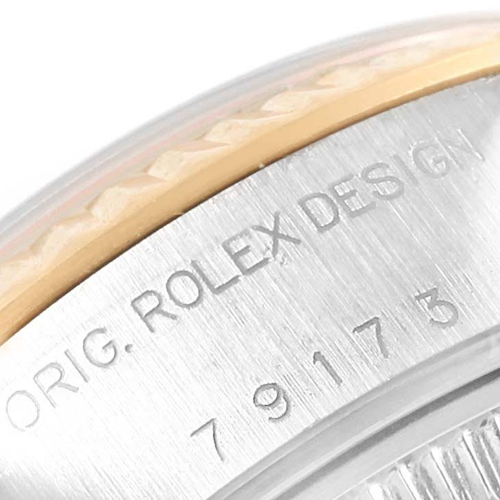 The image shows a close-up of the case side and bezel of a Rolex Datejust 79173 Women's Stainless Steel Grey Dial 79173 Women's Stainless Steel Grey Dial, featuring part of the model number and design engraving.