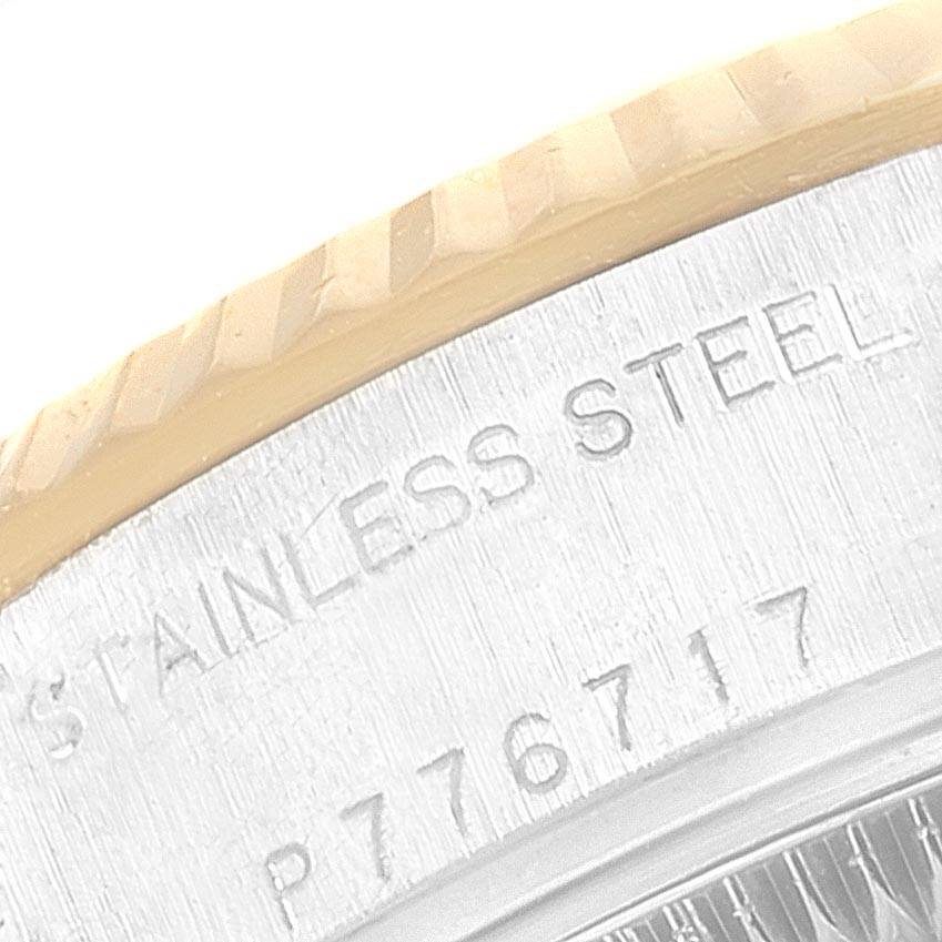 This image shows a close-up of the back case edge of a Rolex Datejust 79173 Women's Steel and Gold (two tone) Black Dial 79173 Women's Steel and Gold (two tone) Black Dial watch, displaying the serial number and "STAINLESS STEEL" engraving.