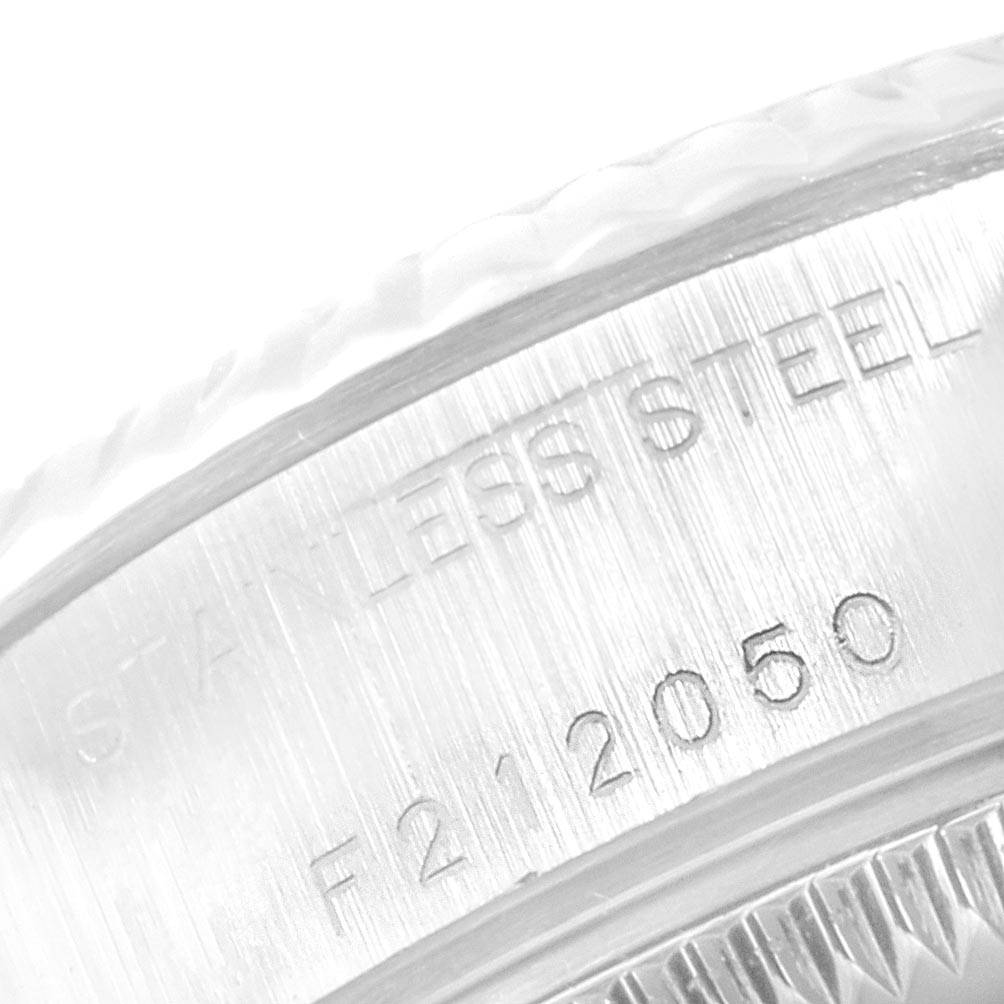 The image shows a close-up of the engraved serial number and "STAINLESS STEEL" inscription on the case side of a Rolex Datejust 79174 Women
s Stainless Steel Silver Dial 79174 Women
s Stainless Steel Silver Dial watch.