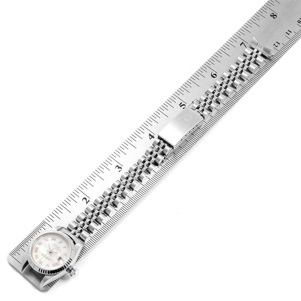 This image shows a Rolex Datejust 79174 Women
s Stainless Steel Mother of Pearl Dial 79174 Women
s Stainless Steel Mother of Pearl Dial watch lying flat, measured against a ruler, highlighting the watch case and bracelet.