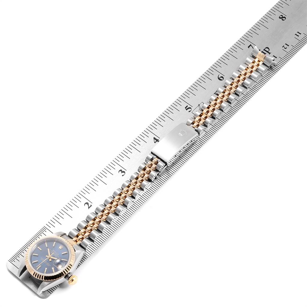 The image shows a top-down view of a Rolex Datejust 69173 Women's Stainless Steel Blue Dial 69173 Women's Stainless Steel Blue Dial watch aligned with a ruler, highlighting the case, dial, and bracelet.