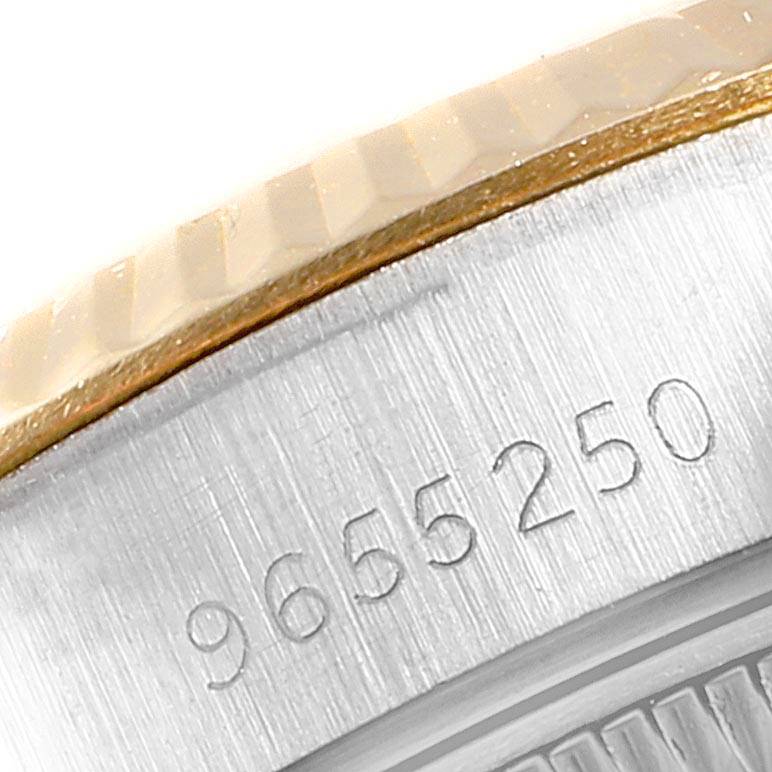 The image is a close-up of the Rolex Datejust 69173 Women's Stainless Steel Blue Dial 69173 Women's Stainless Steel Blue Dial model showing part of the fluted bezel and the serial number on the case.
