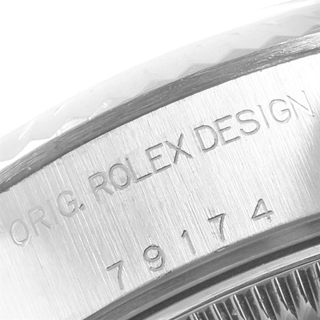 This image shows a close-up of the engraved case side and bezel of a Rolex Datejust 79174 Women
s Stainless Steel Pink Dial 79174 Women
s Stainless Steel Pink Dial watch.