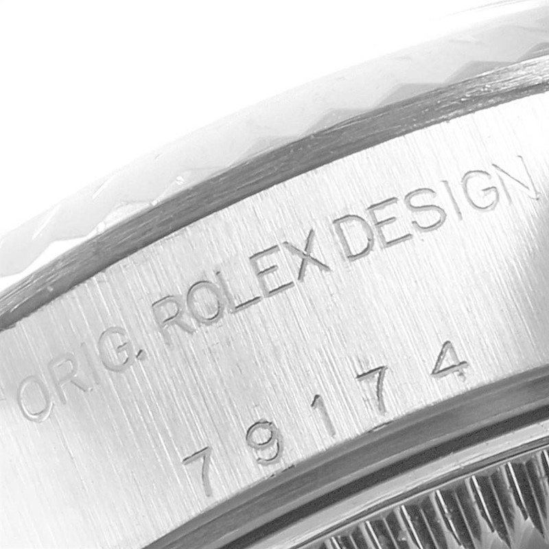 This image shows a close-up of the engraved case side and bezel of a Rolex Datejust watch.