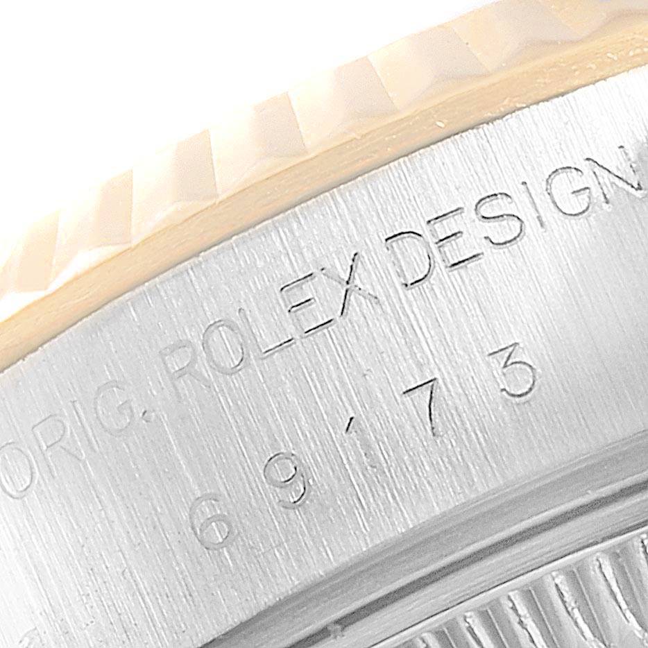 This close-up image shows the bezel and engraved side details of the Rolex Datejust 69173 Women's Stainless Steel White Dial 69173 Women's Stainless Steel White Dial watch.