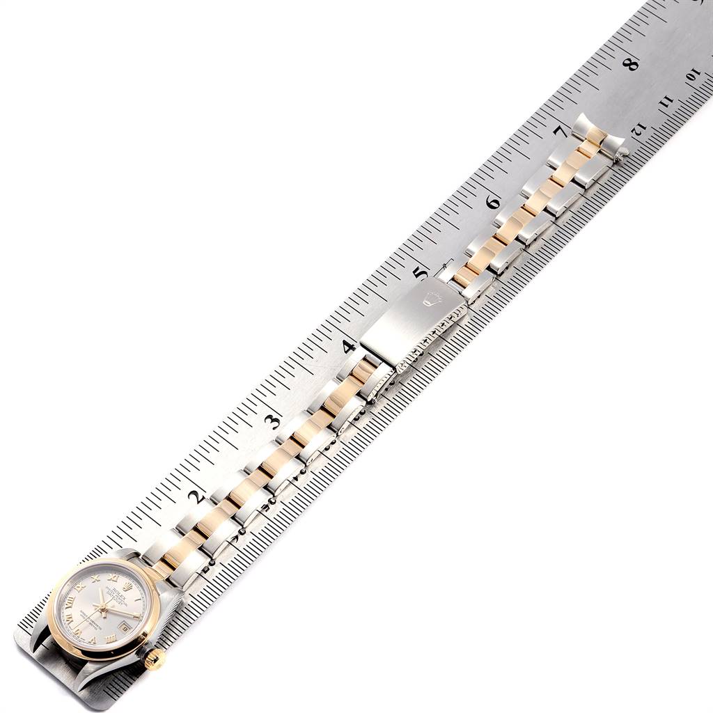 This image shows a Rolex Datejust 79163 Women's Steel and Gold (two tone) Grey Dial 79163 Women's Steel and Gold (two tone) Grey Dial watch laid flat next to a ruler, displaying the entire bracelet and face.