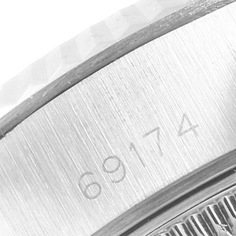 The image shows a close-up angle of the case side and part of the fluted bezel of a Rolex Datejust 69174 Women
s Stainless Steel Silver Dial 69174 Women
s Stainless Steel Silver Dial model, revealing the engraved model number "69174."