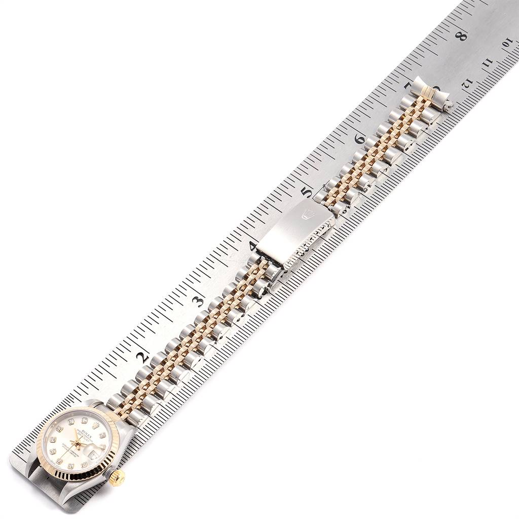 The image shows a Rolex Datejust 79173 Women's Stainless Steel Silver Dial 79173 Women's Stainless Steel Silver Dial watch laid flat alongside a ruler, highlighting its bracelet and clasp.