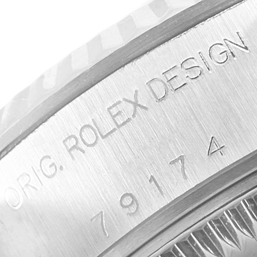 The image shows a close-up of the engraving on the case side of a Rolex Datejust 79174 Women's Stainless Steel Mother of Pearl Dial 79174 Women's Stainless Steel Mother of Pearl Dial watch.