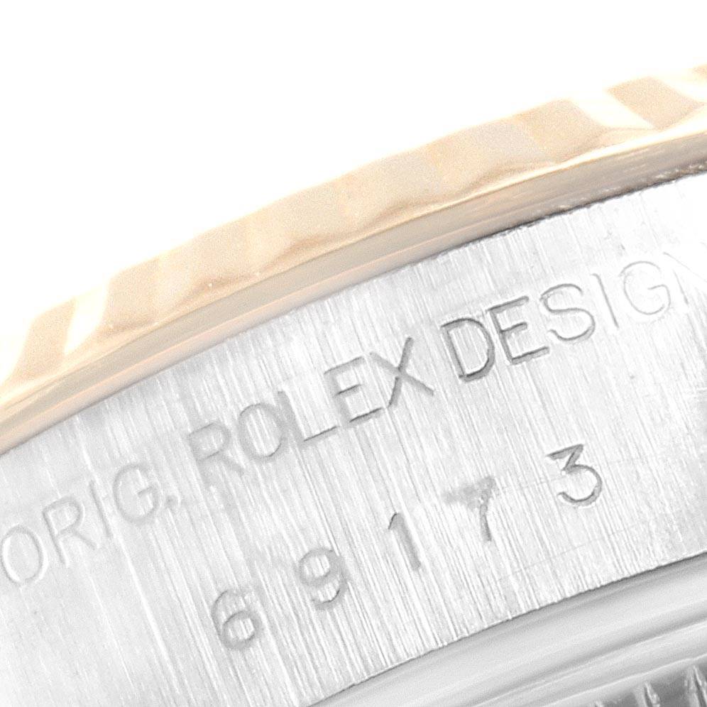 The image shows the edge and side of the case of a Rolex Datejust 69173 Women's Steel and Gold (two tone) Silver Dial 69173 Women's Steel and Gold (two tone) Silver Dial watch, featuring the engraved model and serial number.