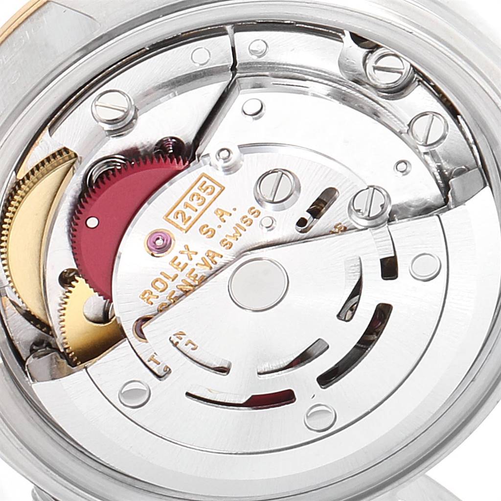The image shows a close-up of the Rolex Datejust 69173 Women's Steel and Gold (two tone) Silver Dial 69173 Women's Steel and Gold (two tone) Silver Dial's movement mechanism, highlighting gears and components.
