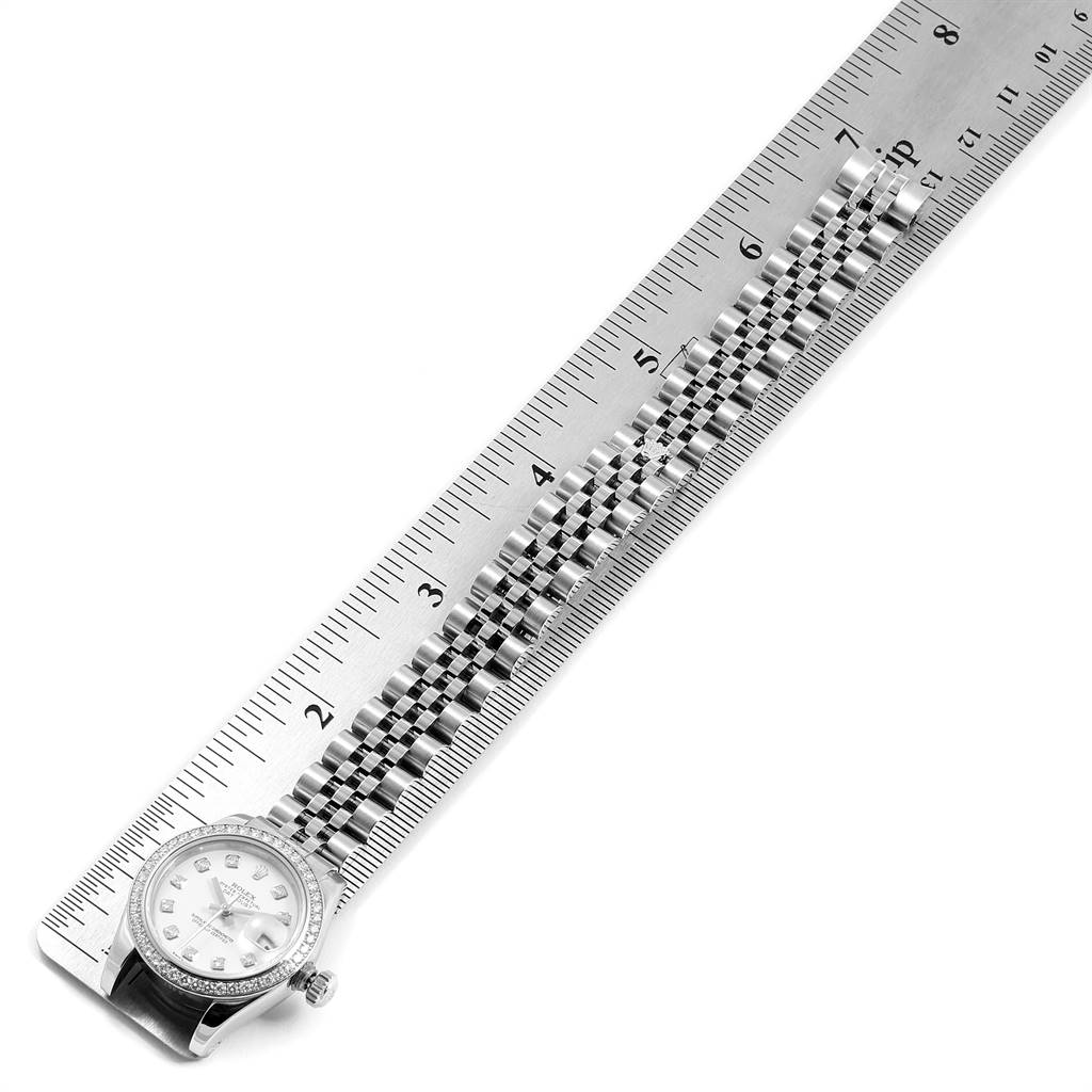 The image shows the Rolex Datejust 179384 Women's Stainless Steel White Dial 179384 Women's Stainless Steel White Dial watch face and band laid alongside a ruler for measurement.