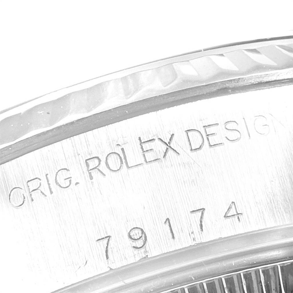 This close-up image shows the engraved model and serial number on the side of the Rolex Datejust 79174 Women
s Stainless Steel Mother of Pearl Dial 79174 Women
s Stainless Steel Mother of Pearl Dial watch
s case.