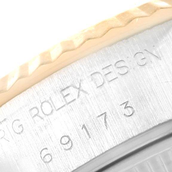 This is a close-up of the bezel and casing of a Rolex Datejust 69173 Women's Stainless Steel Champagne Dial 69173 Women's Stainless Steel Champagne Dial watch, showing part of the model number and the engraving.