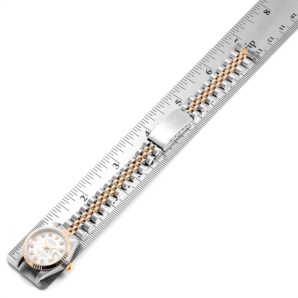 The Rolex Datejust 69173 Women's Stainless Steel Silver Dial 69173 Women's Stainless Steel Silver Dial watch is shown from above, highlighting the face, bracelet, and clasp, with a ruler measuring its length.