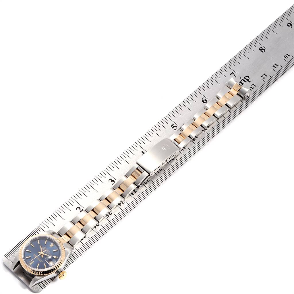 The image shows a Rolex Datejust 79173 Women
s Steel and Gold (two tone) Blue Dial 79173 Women
s Steel and Gold (two tone) Blue Dial watch laid flat, with the face and entire bracelet visible, measured against a ruler.