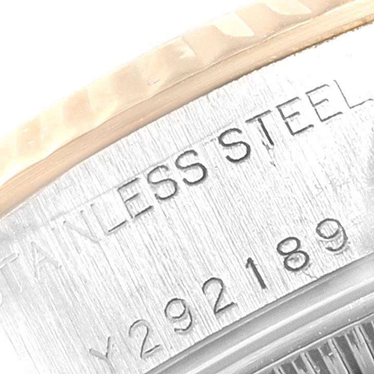 This close-up image shows the engraving on the case back of a Rolex Datejust 79173 Women
s Steel and Gold (two tone) Blue Dial 79173 Women
s Steel and Gold (two tone) Blue Dial watch, highlighting the stainless-steel material and part of the serial number.