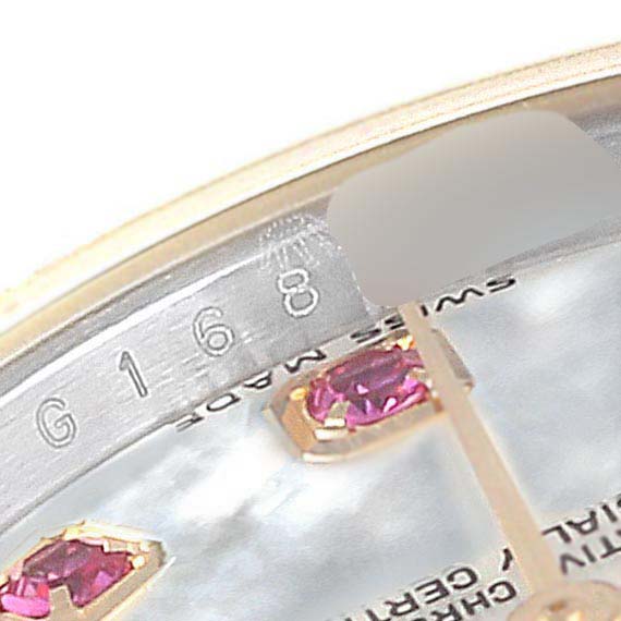 This close-up shows the dial edge, a serial number, gem markers, and partial text on the Rolex Datejust 179173 Women's Steel and Gold (two tone) Mother of Pearl Dial 179173 Women's Steel and Gold (two tone) Mother of Pearl Dial watch.