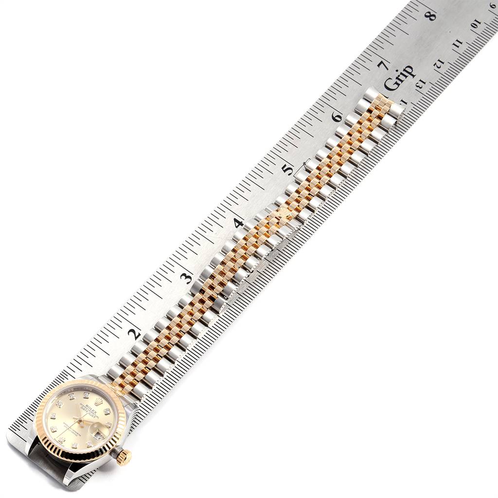 The image shows the Rolex Datejust 279173 Women's Steel and Gold (two tone) Champagne Dial 279173 Women's Steel and Gold (two tone) Champagne Dial watch face and full bracelet, measured against a ruler from an overhead angle.