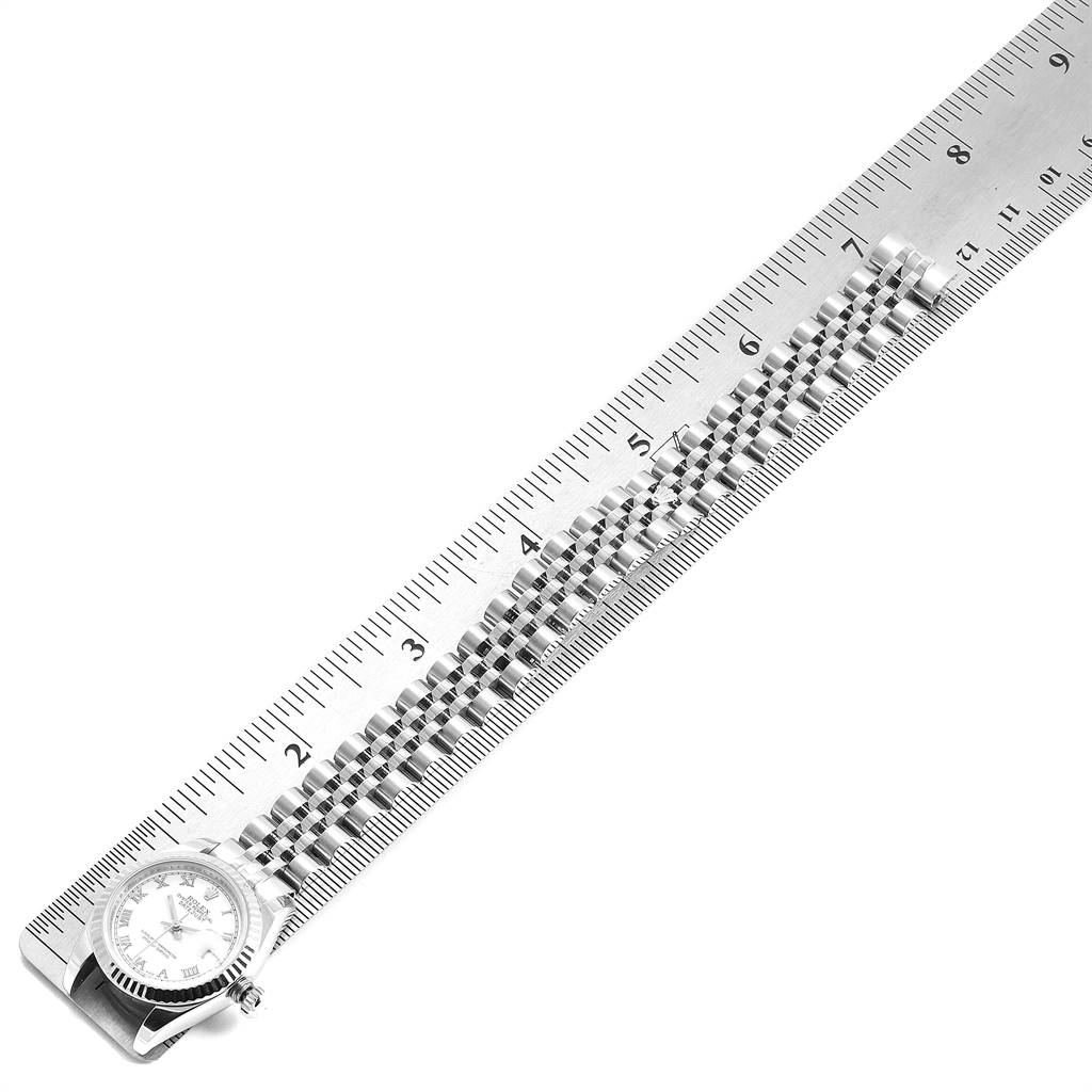 The image shows a partial view of a Rolex Datejust 179174 Women's Stainless Steel White Dial 179174 Women's Stainless Steel White Dial watch, with the watch face and band aligned next to a ruler for measurement.