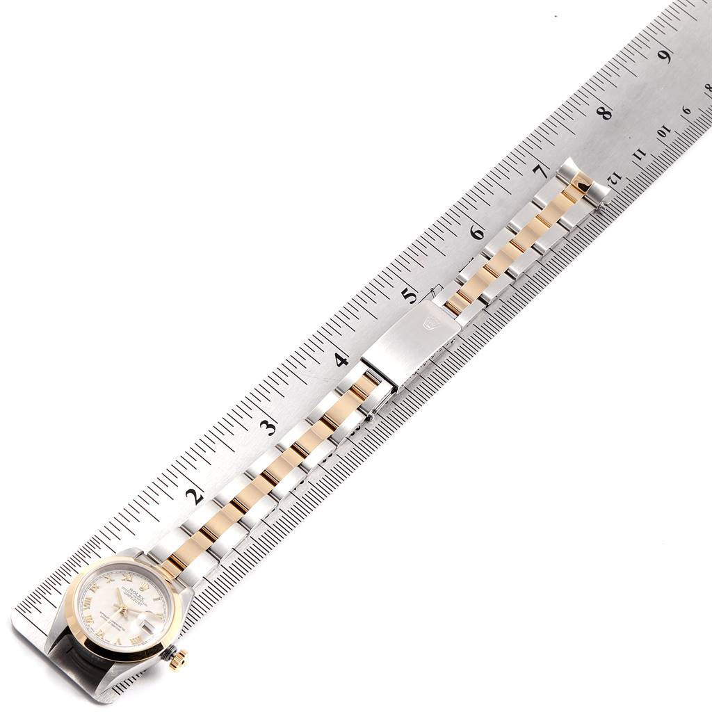 The image shows the Rolex Datejust 69163 Women's Stainless Steel Beige Dial 69163 Women's Stainless Steel Beige Dial model watch, including its face and its metal bracelet against a measuring ruler.