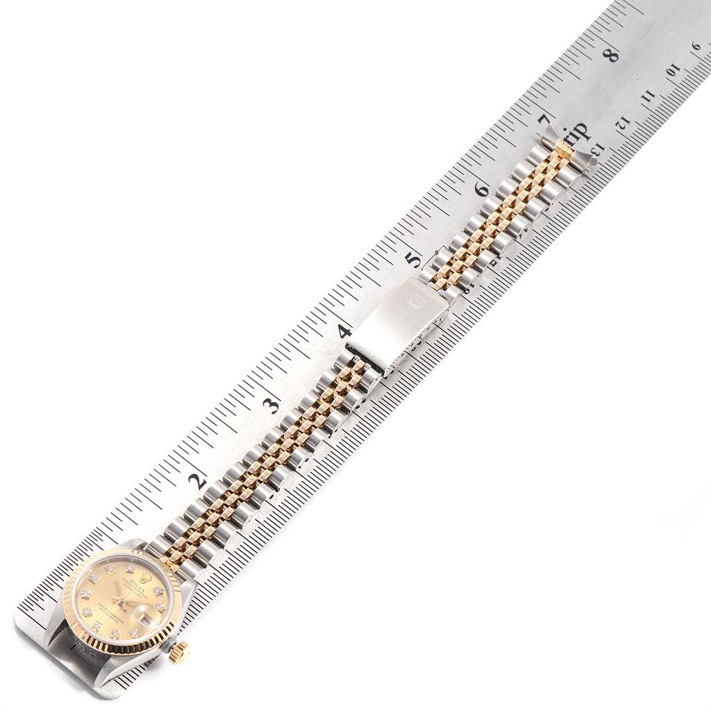 The image shows a Rolex Datejust 69173 Women's Stainless Steel Champagne Dial 69173 Women's Stainless Steel Champagne Dial watch laid flat on a ruler, displaying the dial, bracelet, and clasp.