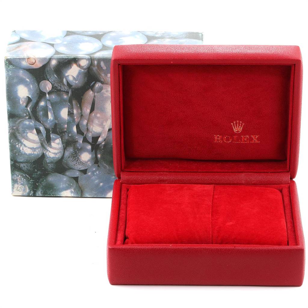 This image shows a red, open Rolex Datejust 69173 Women's Stainless Steel Champagne Dial 69173 Women's Stainless Steel Champagne Dial watch box and a closed outer box with a design.